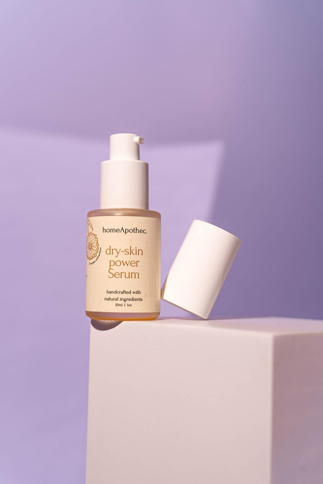 Dry Skin Power Serum with its cap off on a white block