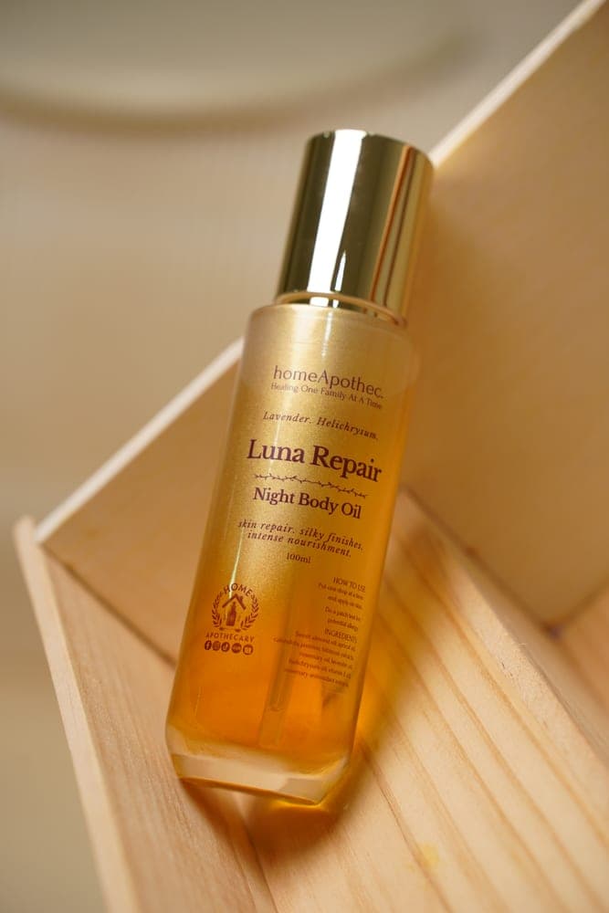 Luna Repair Night Body Oil resting in a pine crate