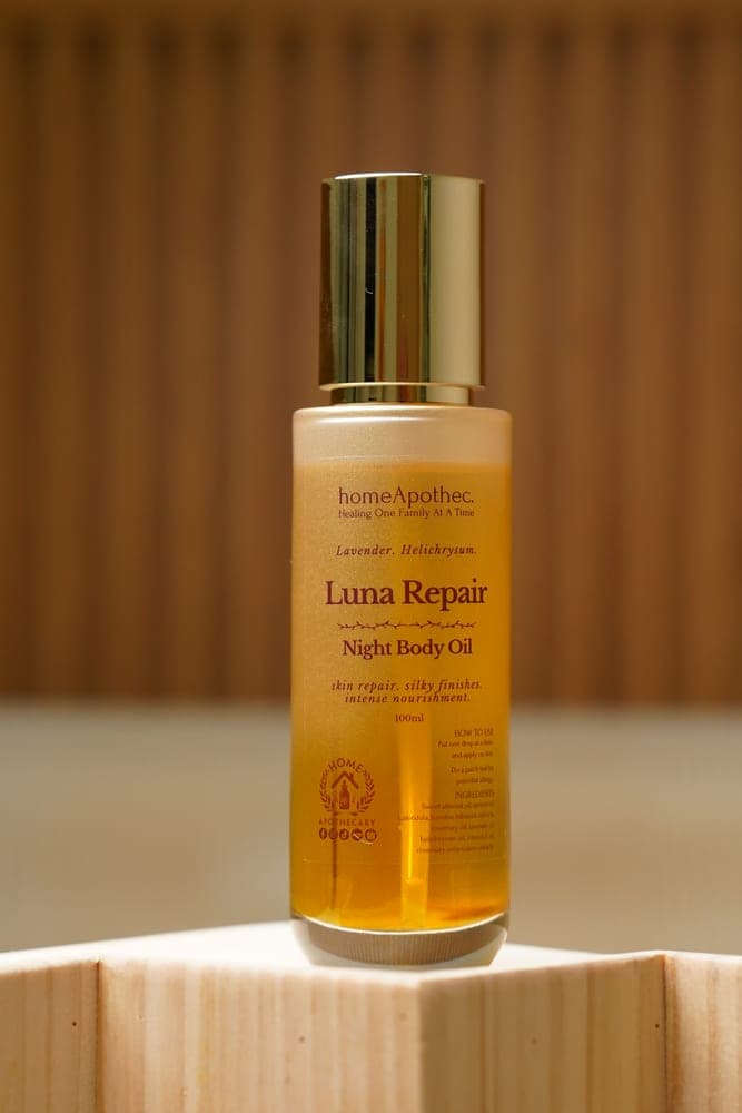 Luna Repair Night Body Oil on a pine block