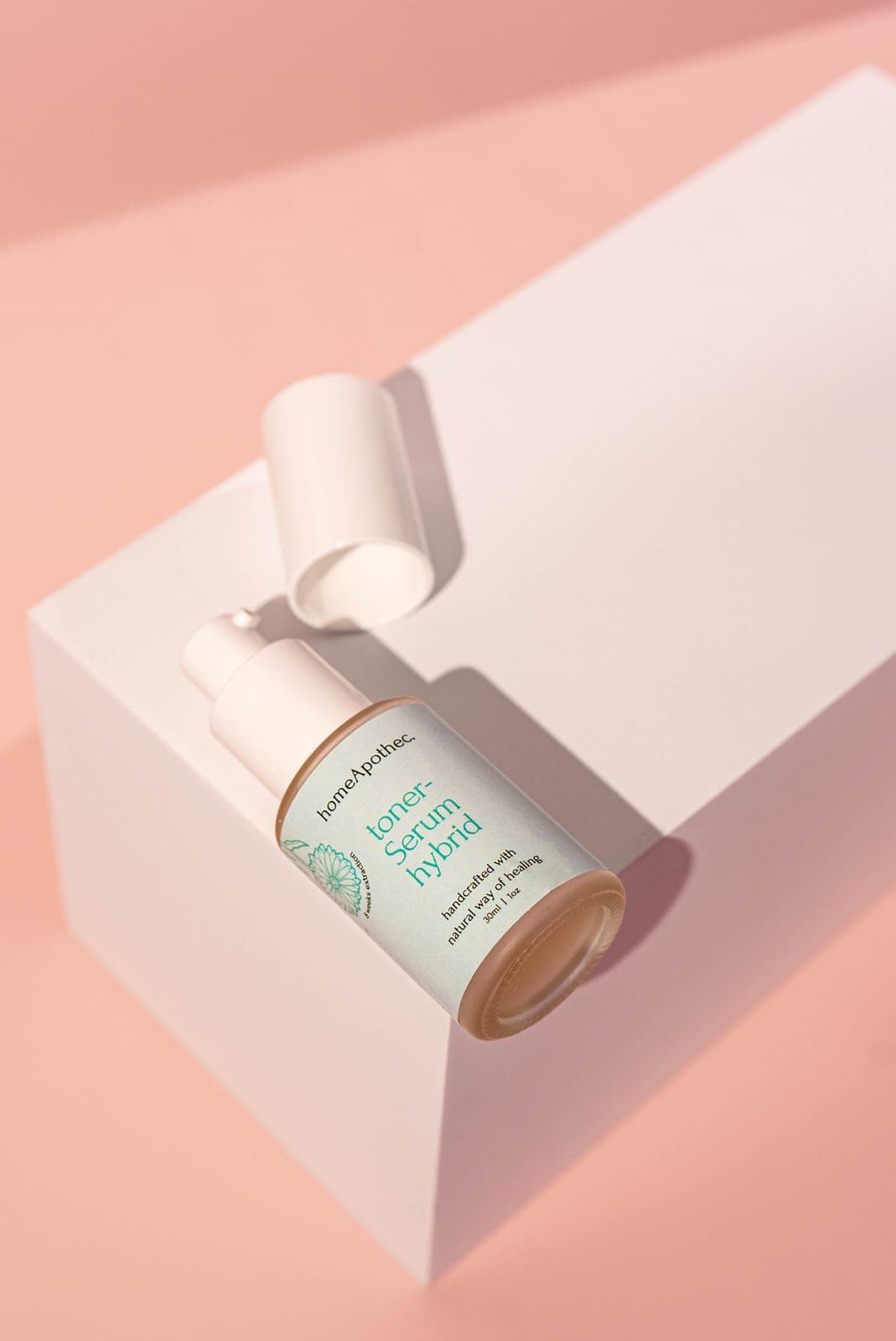 Toner Serum Hybrid with its cap off on a white block